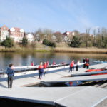 Rowers launching boats from specialist rowing pontoon