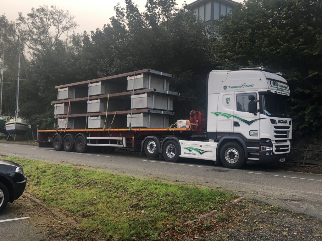 Lorry with marina pontoons stacked on trainer