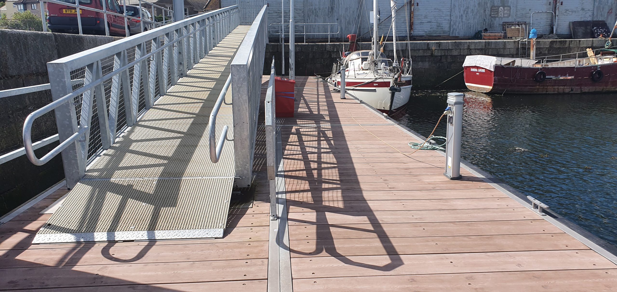 Gangway leading down to a pontoon with service bollard