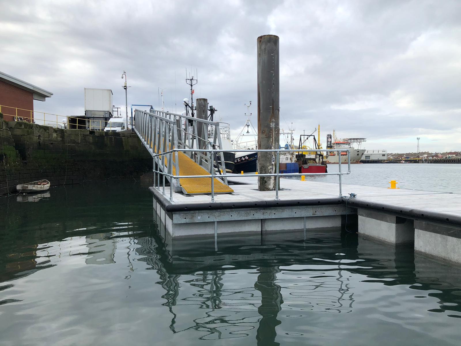 Floating pontoon jetty with pile and gangway