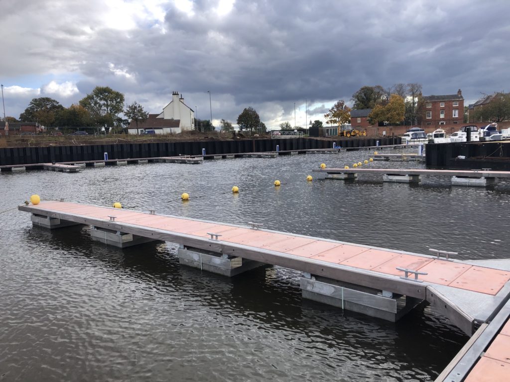 Single marina pontoon with terracotta coloured decking