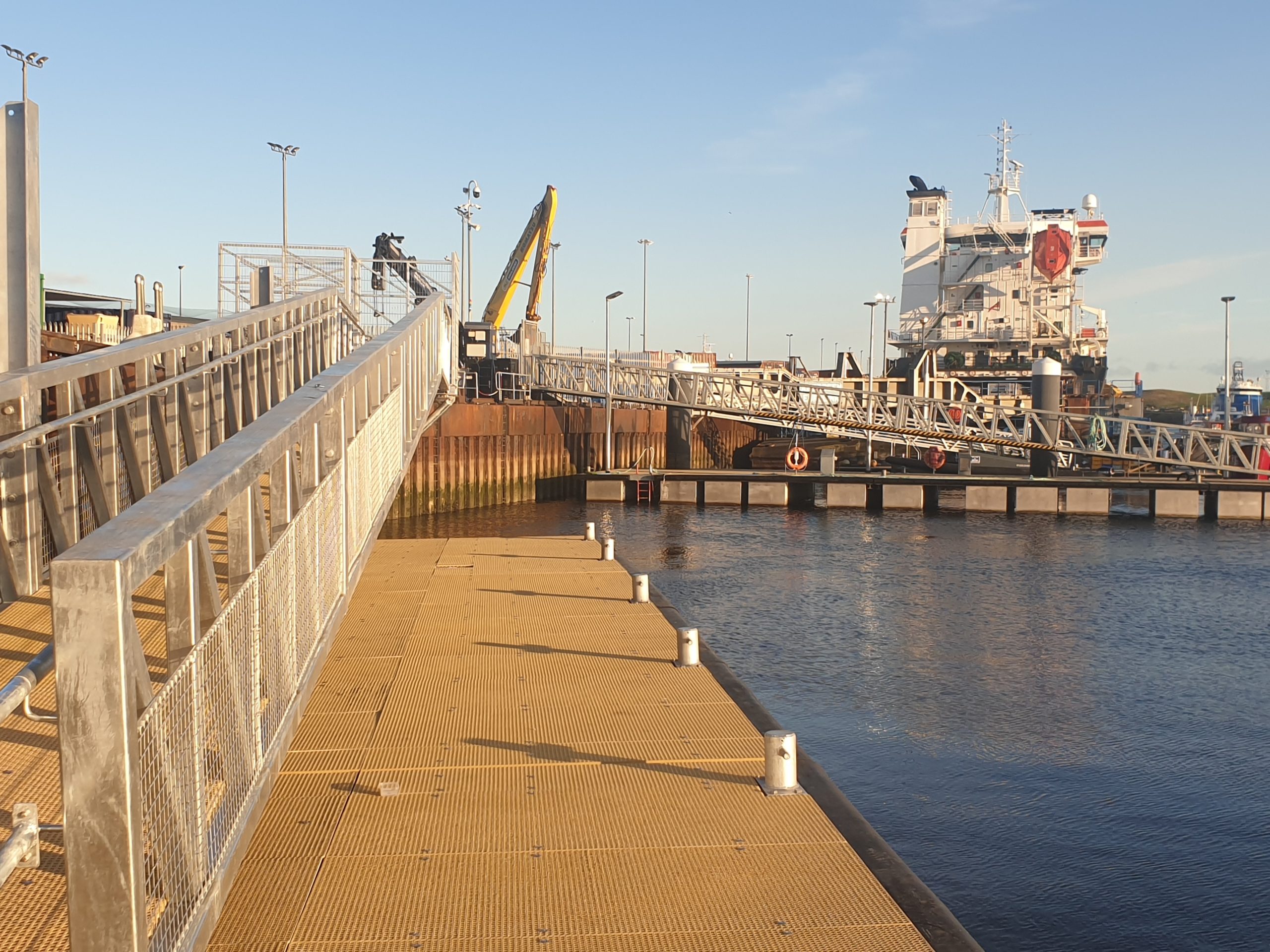 Pontoon berth with gangway with large ship in the background