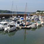 Marina with boats moored to pontoons inside