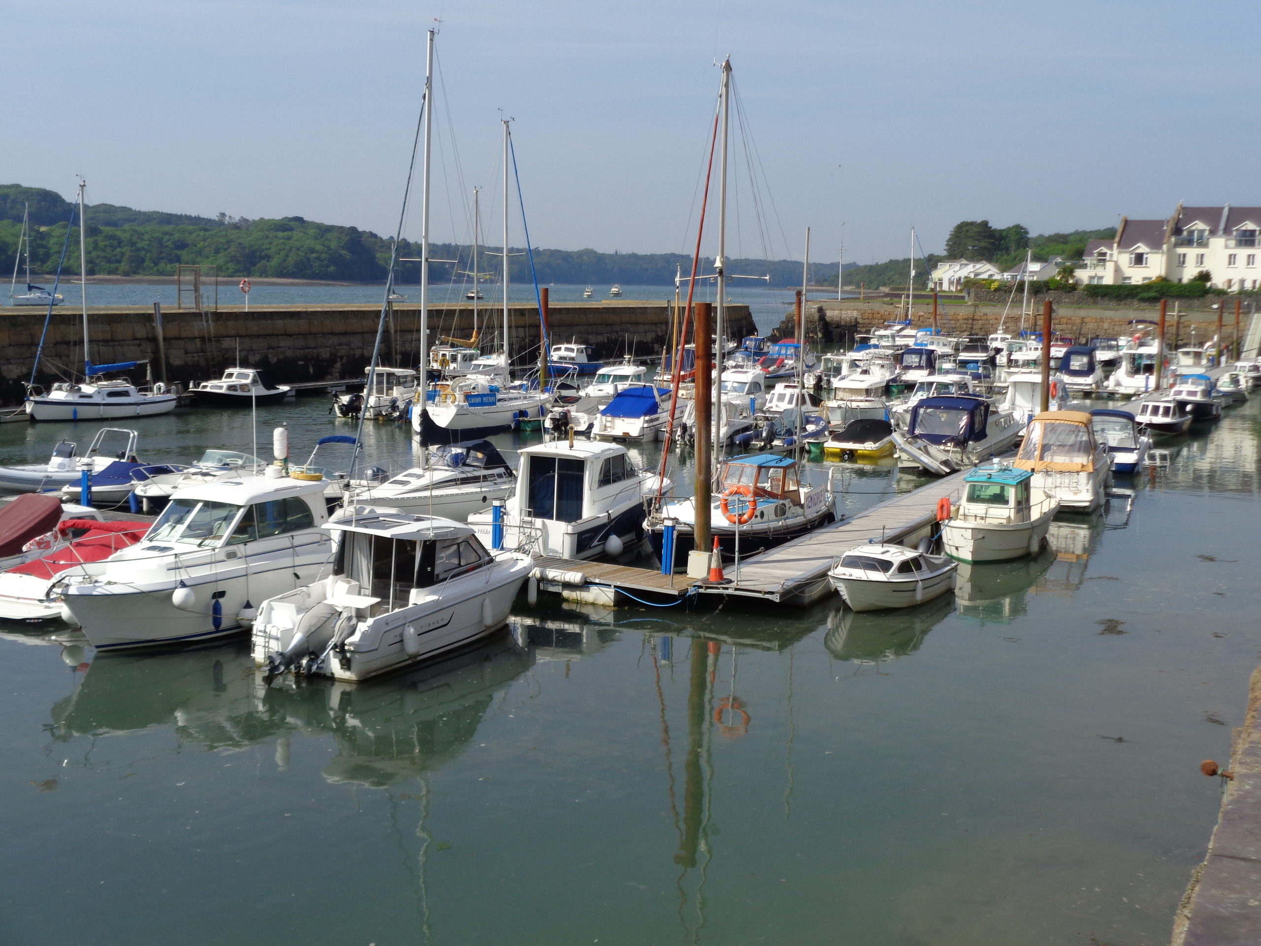 Marina with boats moored to pontoons inside