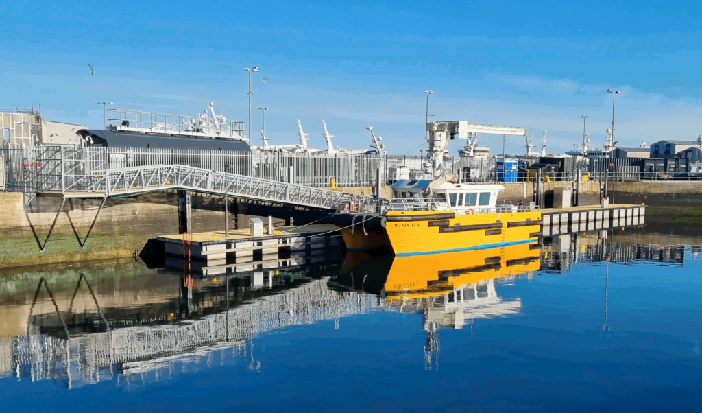 Heavy duty pontoon with crew transfer vessel moored alongside