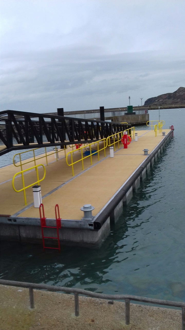 Black gangway leading down to pontoons with yellow railings