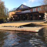 Exterior of Kings School Rowing club with a view into the boat house