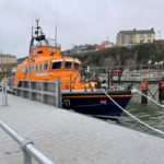 RNLU all-weather lifeboat tied alongside pontoon with guard rails
