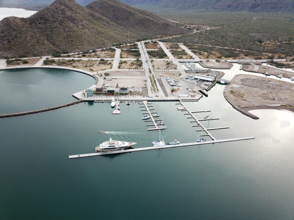Aerial view of superyacht harbour surrounded by mountainous peaks