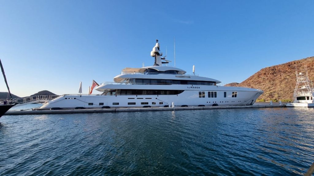 Superyacht berthed alongside concrete breakwater