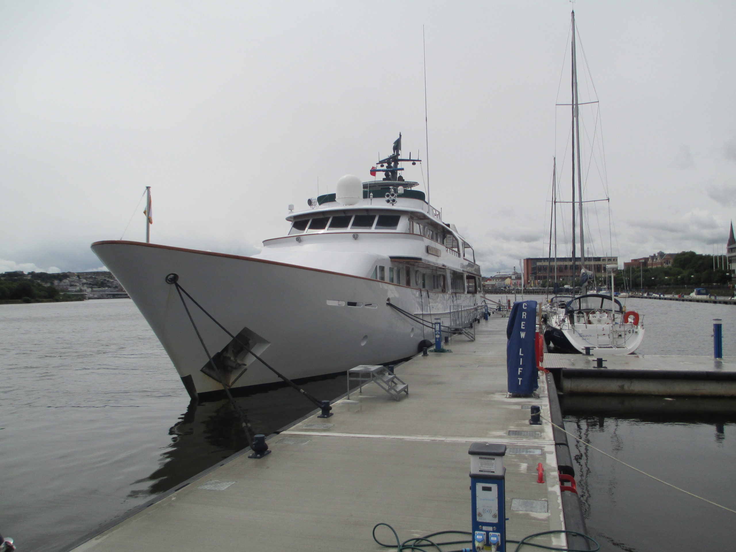 Superyacht moored alongside concrete breakwater