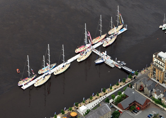 Aerial view of Clipper yachts moored alongside concrete breakwater in Derry