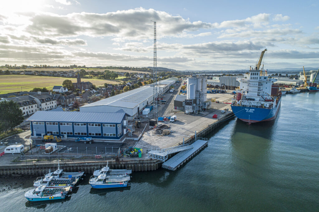 Aerial view of 30m CTV pontoon alongside quay wall with ship in the background