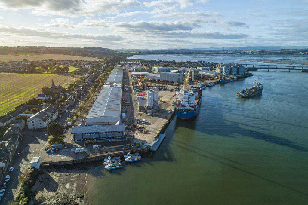 Aerial view of 30m CTV pontoon alongside quay wall with ship in the background