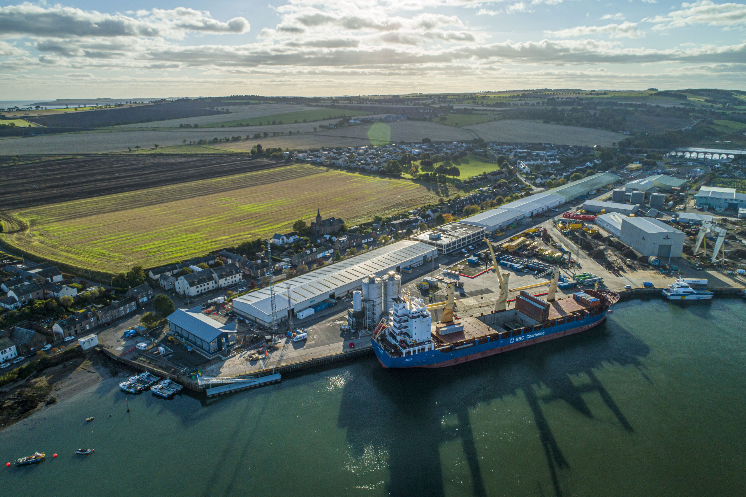 Aerial view of 30m CTV pontoon alongside quay wall with ship berth head of it