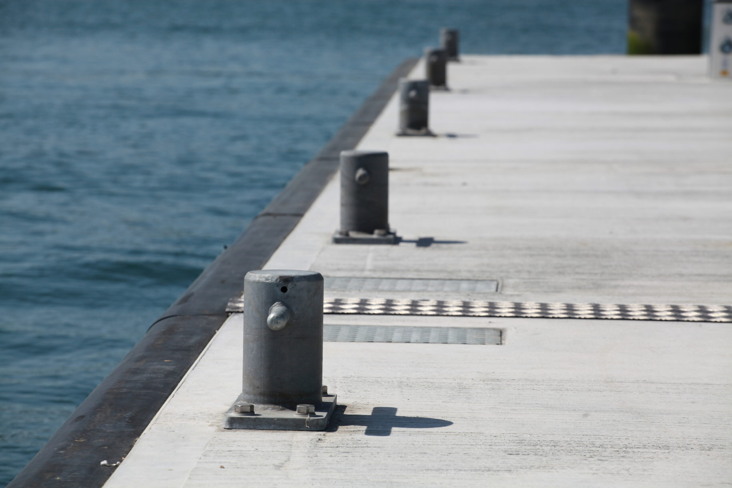 Row of high strength bollards on concrete pontoon