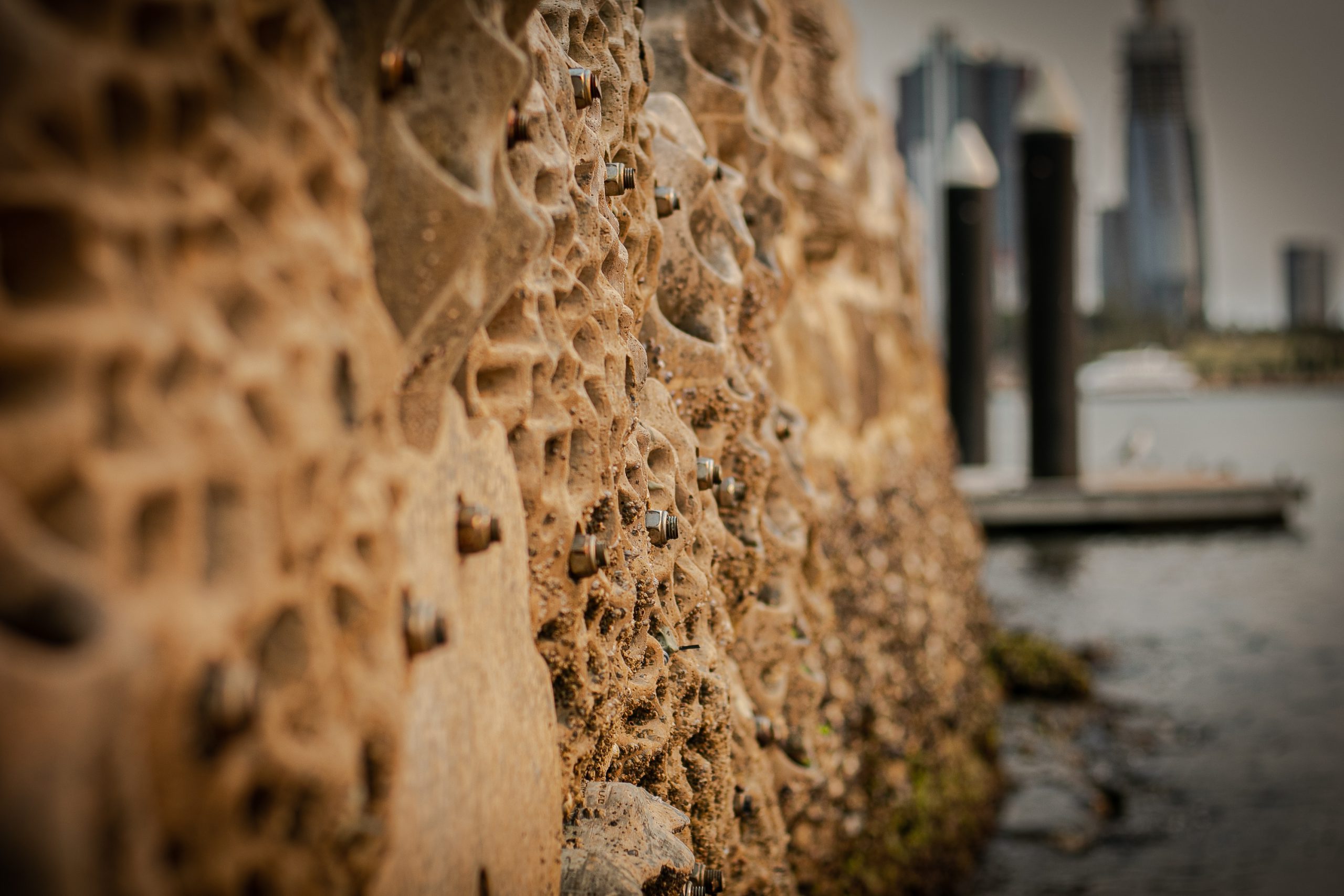 Sand coloured concrete panels shaped like a rocky foreshore