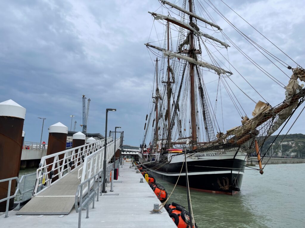 Large classic yacht alongside floating concrete pontoon