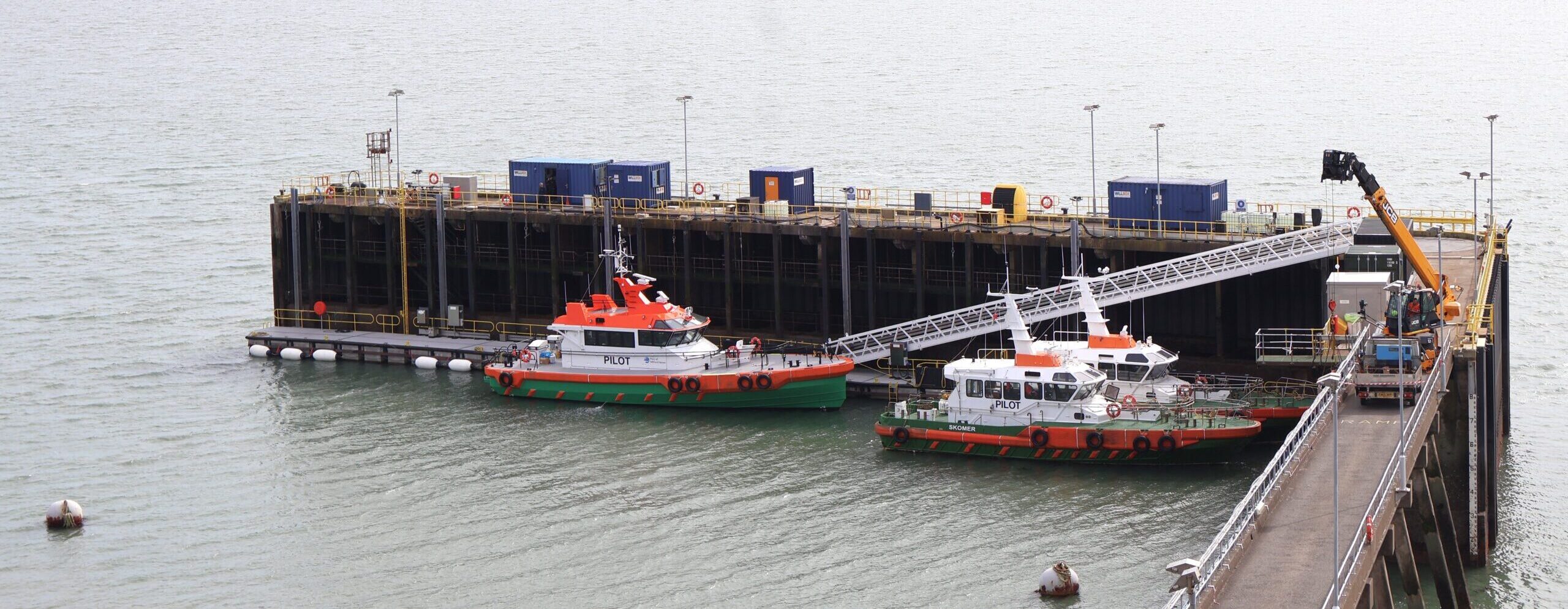 Tugs alongside the new pontoon at the Port of Milford Haven in Pembrokeshire, Wales